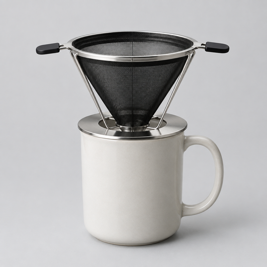 Black folding stainless steel pour-over coffee filter on a ceramic mug